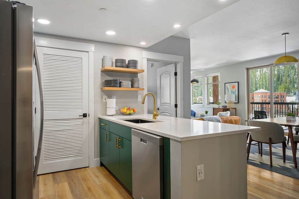 The kitchen overlooks the dining and living areas (door to washer/dryer room)
