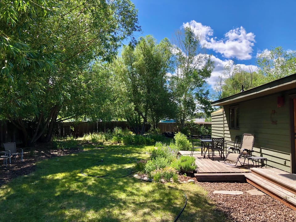 Spacious back yard with fire pit and mature gardens and views of the Tetons.