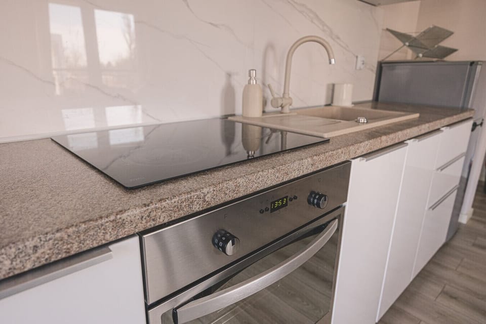 Kitchen with oven and cooktop – enjoy the freedom to cook your own meals during your seaside holiday.