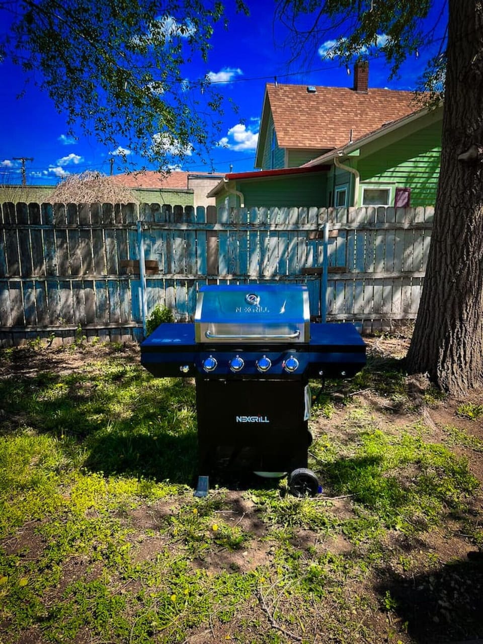 Private backyard with grill, perfect for outdoor dining and cookouts
