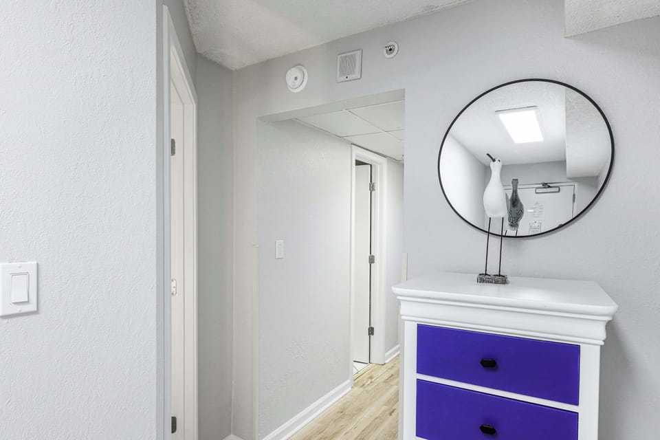 A coastal welcome with a pop of personality—this cheerful entryway sets the tone for your stay. Bright accents, beachy charm, and good vibes start the moment you walk in.