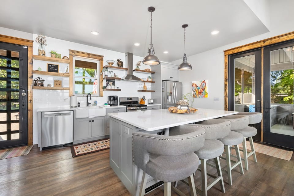 The kitchen island includes four barstools, providing a comfortable space for dining or socializing.
