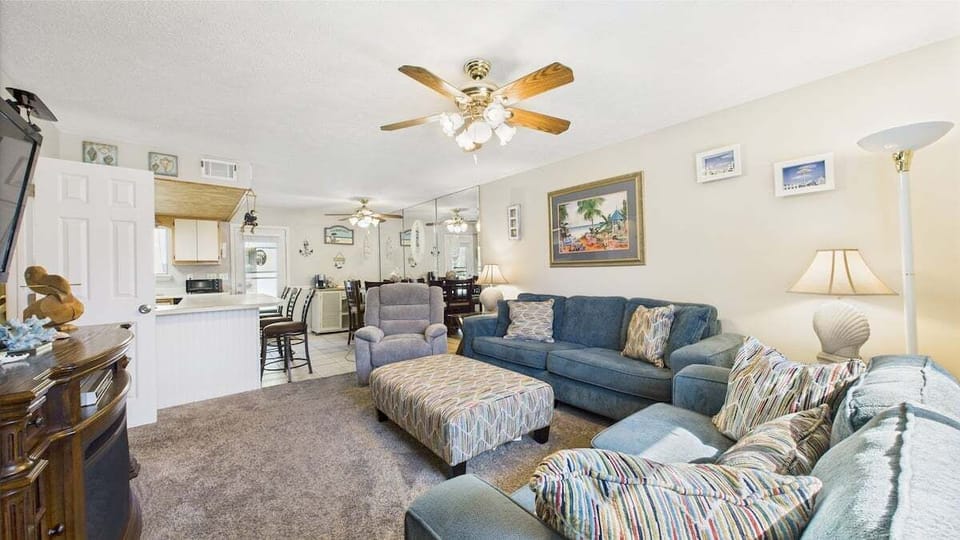 Living area has ample seating and huge TV