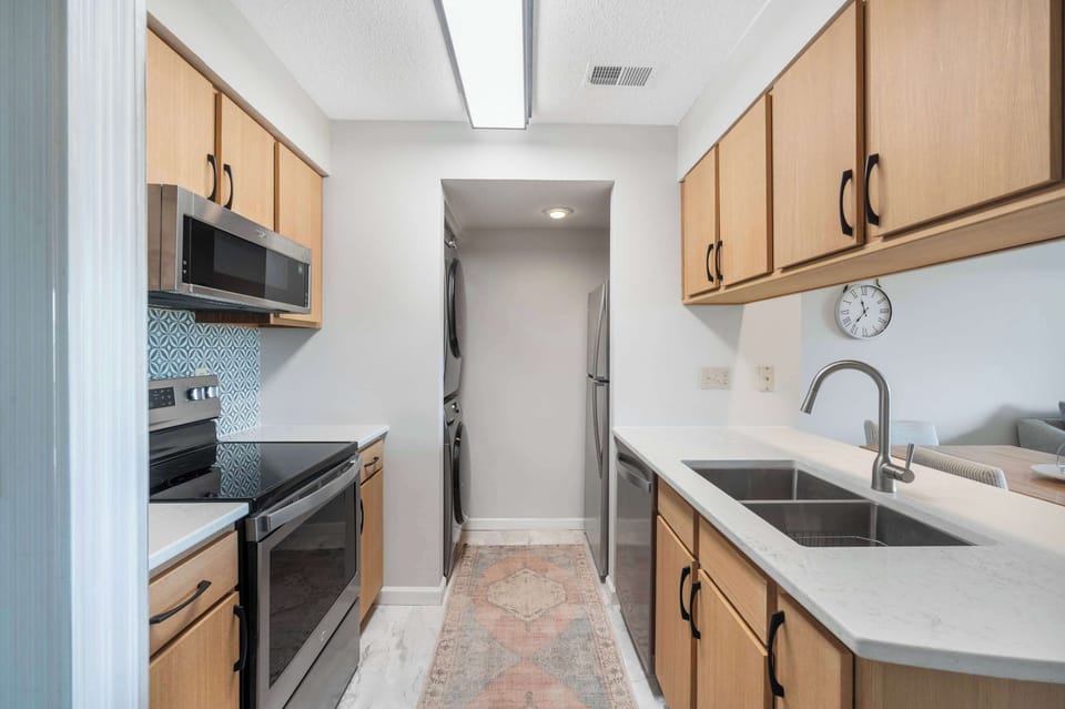 The breezy kitchen offers ample space & every home comfort