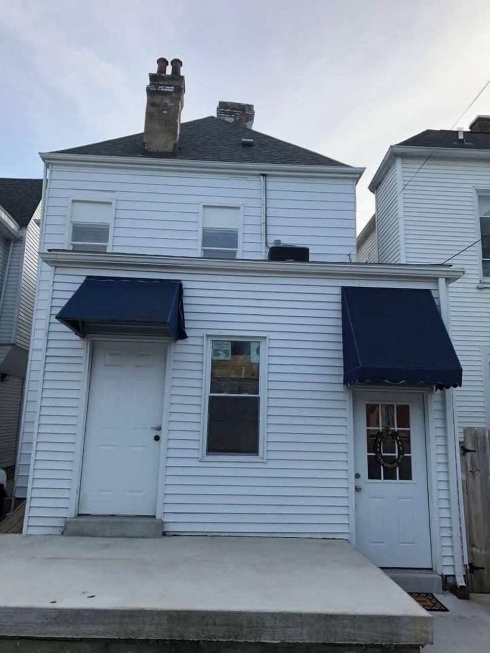 Entrance is the door on the Right 
From the rear of the building. 
You will enter from the rear of the building. Drive through the back  alley and park in the back of the building. Parking is behind the building