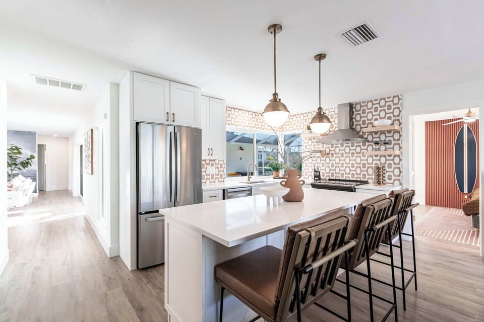 The fully equipped kitchen boasts modern appliances, ample counter space.