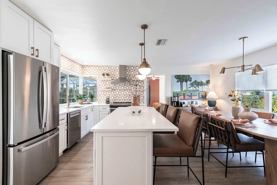 The  kitchen blends sleek design with functionality, creating an inviting and efficient space perfect for both cooking and entertaining.