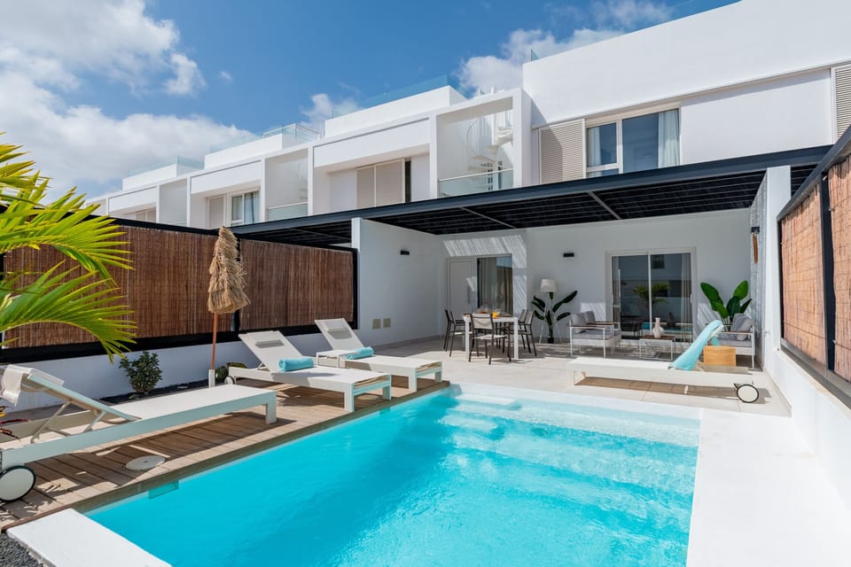 Terrace with outdoor dining area next to the pool.