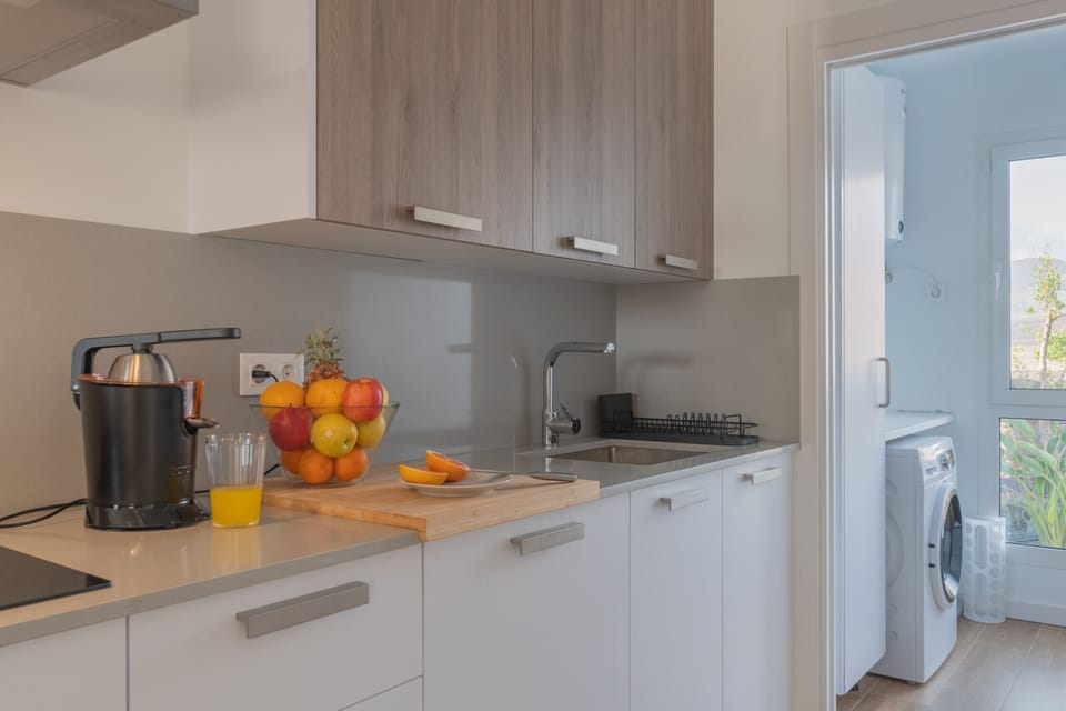 Modern white and wood kitchen, fully equipped.