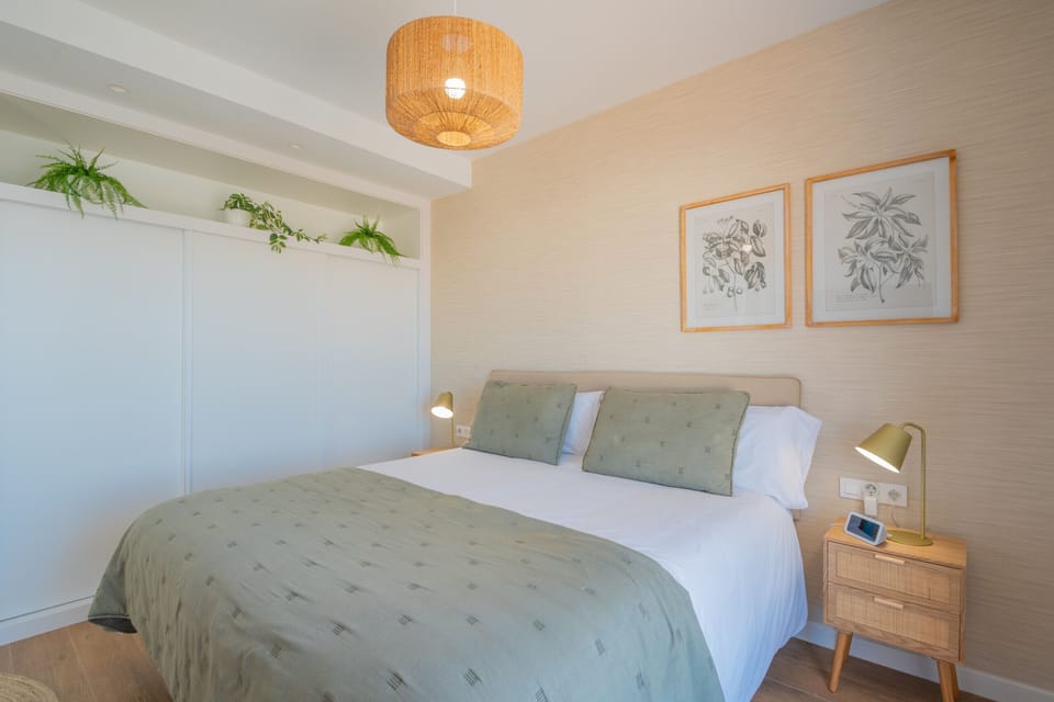 Spacious master suite with large bed and green decor.