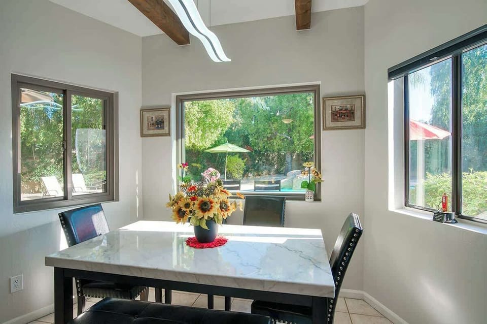 Breakfast nook overlooking pool area and backyard.