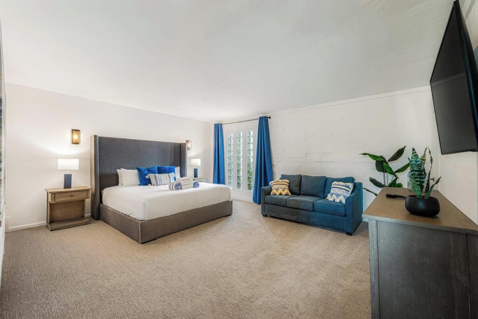 This king bedroom includes extra seating and plenty of room to spread out.