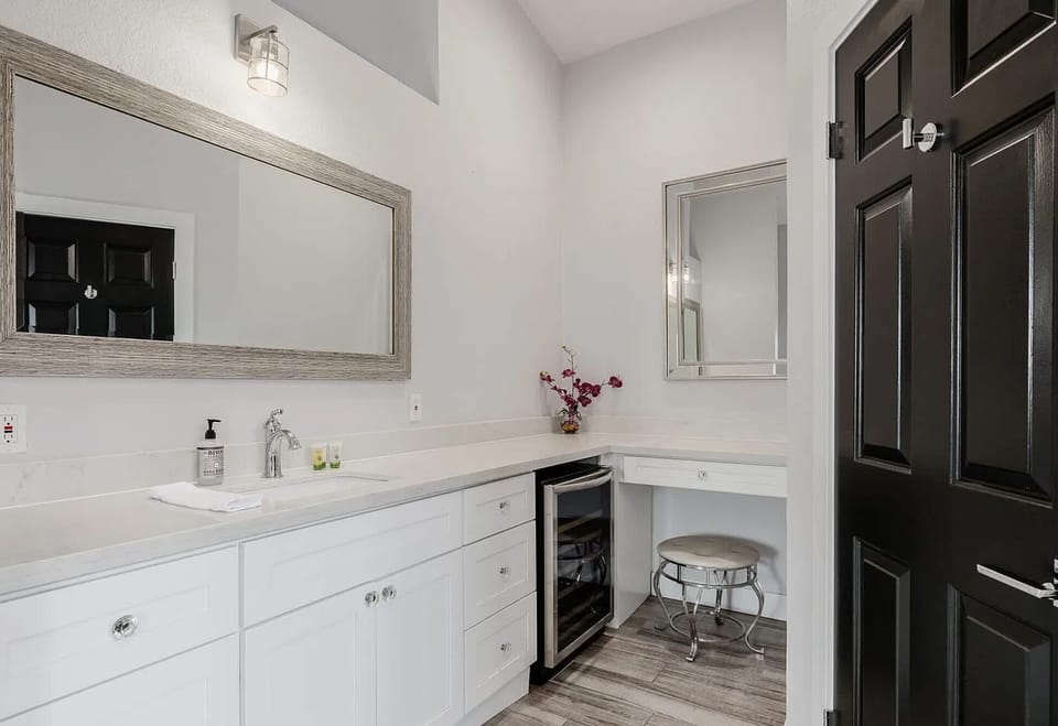 Bright bathroom with custom cabinetry and marble accents