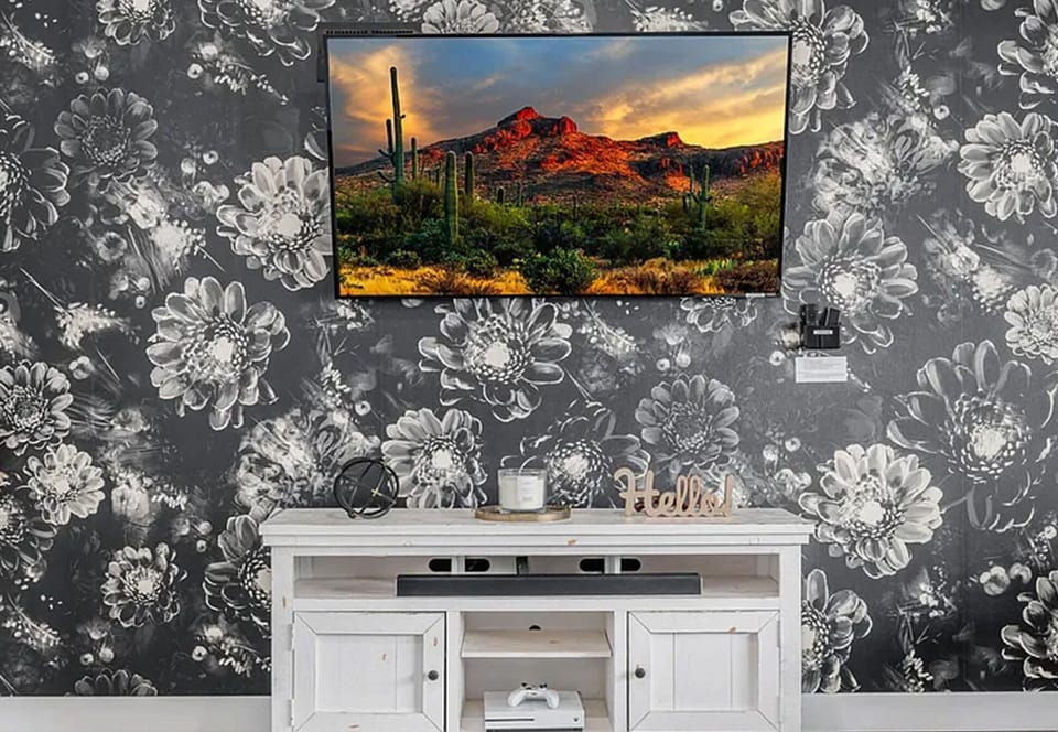 Living area featuring designer wallpaper and modern furnishings