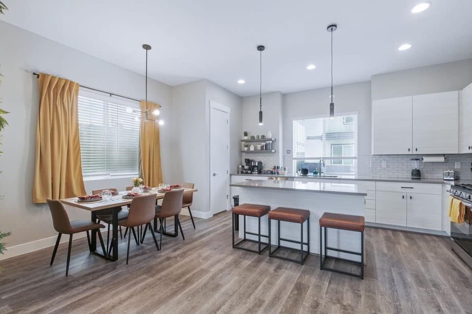 Host memorable meals at the elegant dining table for six or enjoy casual bites at the sleek breakfast bar in this modern, open-concept kitchen.