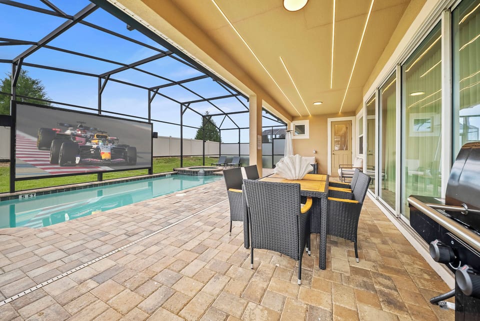 Step outside to this beautifully tiled patio where sleek, modern furniture invites you to relax by the sparkling pool. Enjoy al fresco dining under the shaded lanai, with ample space for gatherings or quiet moments.