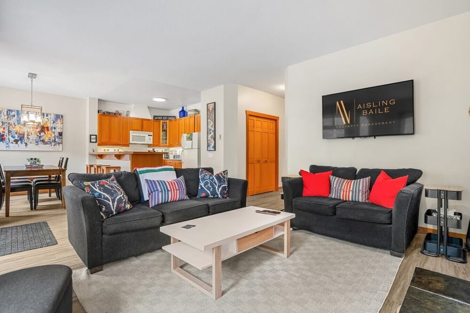 Spacious living room with a TV and a cable package, electric fireplace, board games and cozy seating to wind down after a day filled with activities with a pull-out sofa bed for extra sleeping space (all necessary bedding provided.)
