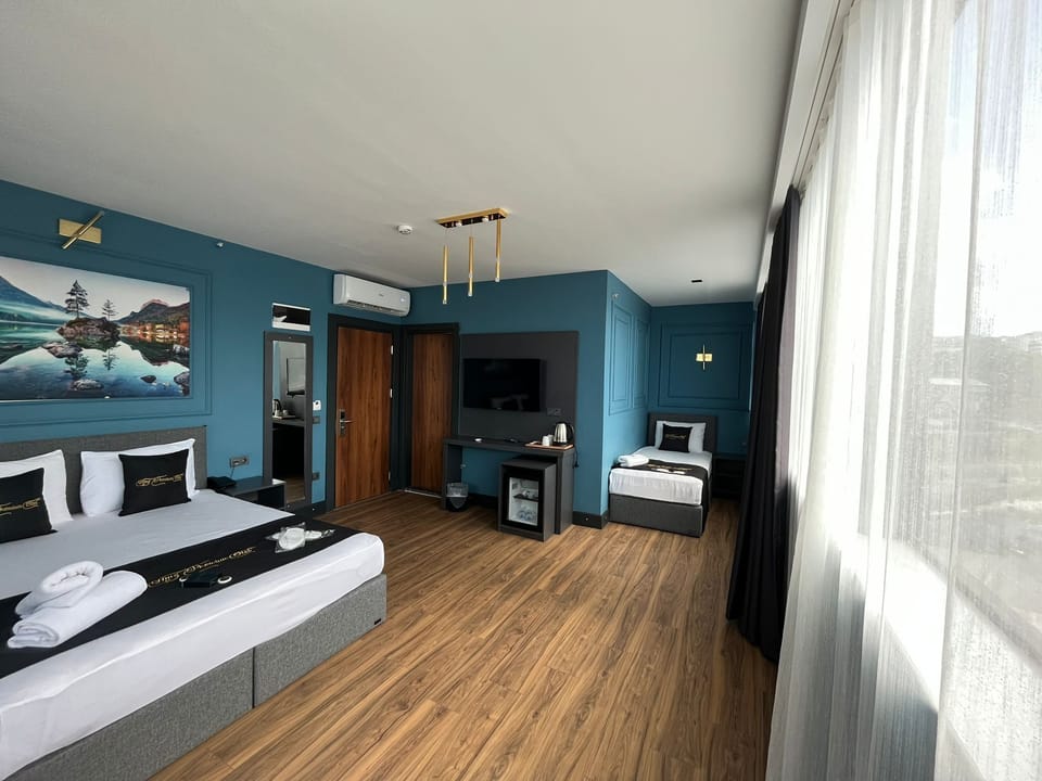 Family Triple Room, City View | In-room safe, desk, laptop workspace, soundproofing