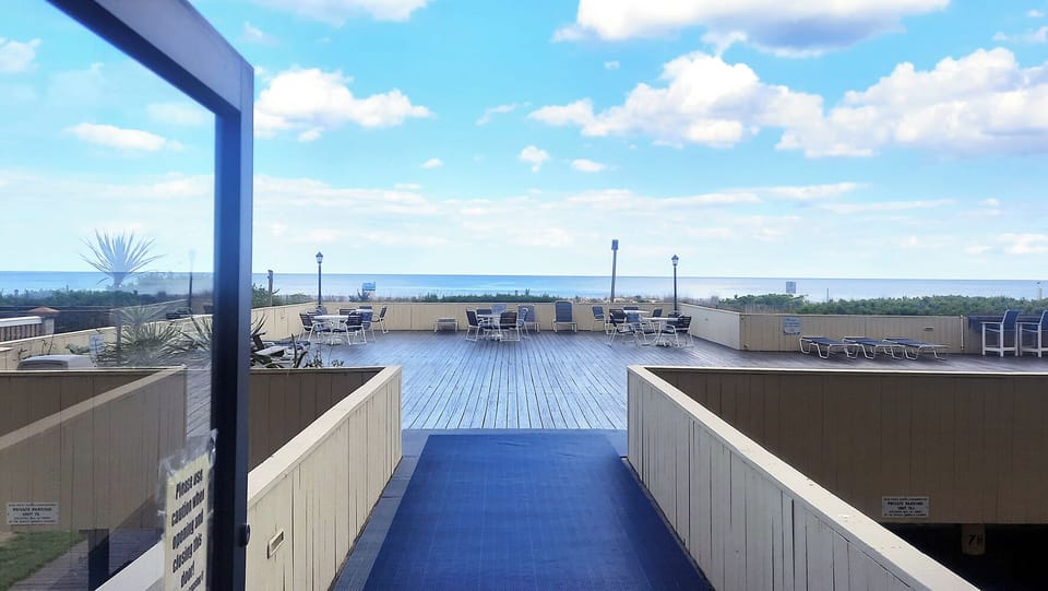 Shared oceanfront deck just steps from the unit for beach relaxation