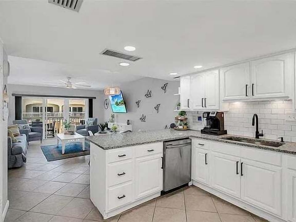 Bright kitchen flows into a cozy living space—perfect for relaxing or entertaining.