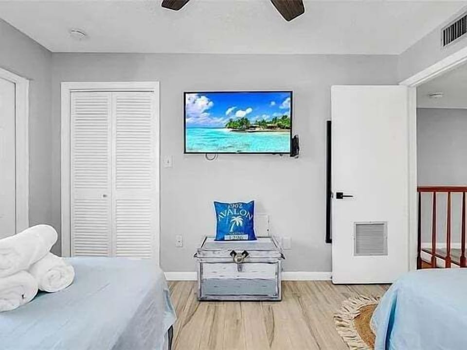 Enjoy this nautical-themed bedroom with a Smart TV—perfect for streaming your favorite shows after a day at the beach!