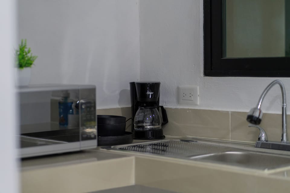 Mini-fridge, microwave, coffee/tea maker, cookware/dishes/utensils
