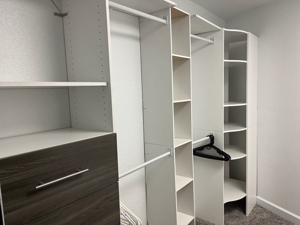 Walk-in closet in west primary suite offers storage space for your personal items and wardrobe.