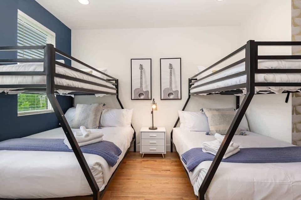 Additional Sleeping Arrangement featuring 2 Twin over Full Bunk Beds, Smart TV, Dresser, and Futon.