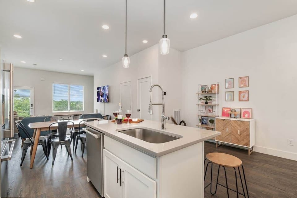 Fully Equipped Kitchen featuring stainless steel appliances and a kitchen island with bar seating for 4 guests.