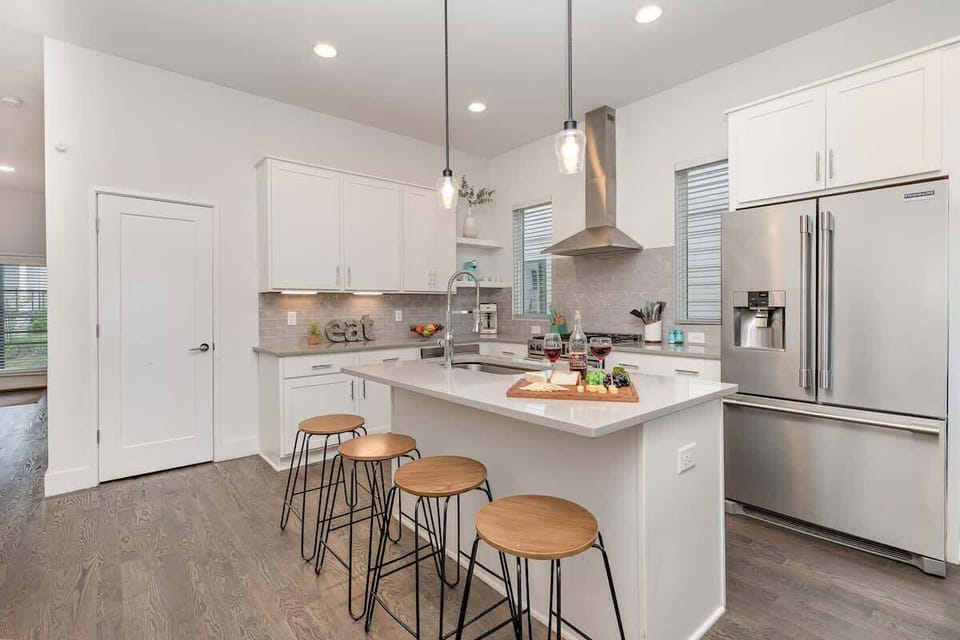 Fully Equipped Kitchen featuring stainless steel appliances and a kitchen island with bar seating for 4 guests.