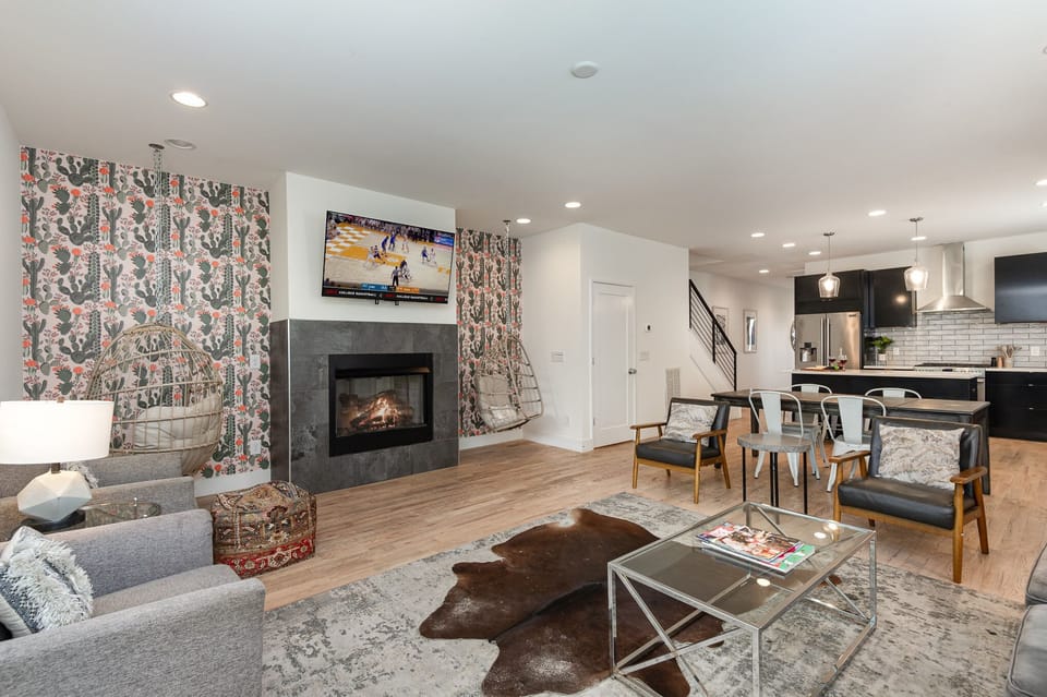 Unit 1: Open-concept living area with cozy furnishings, a Smart TV, and a fireplace.