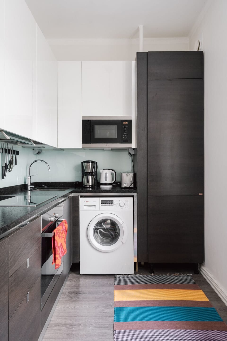 In-unit washing machine with detergent provided – great for longer stays.