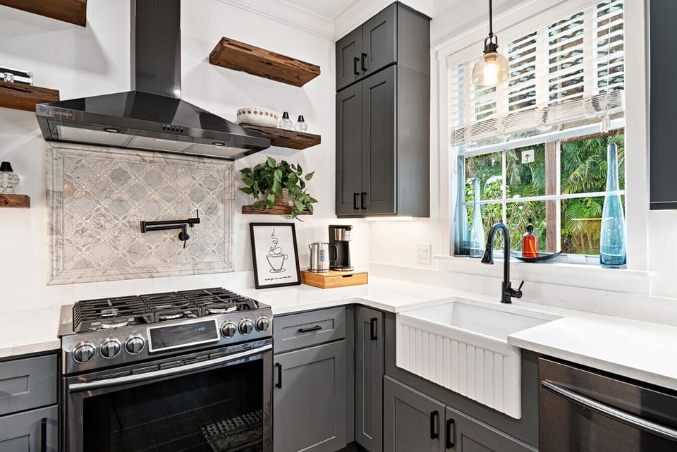 Modern kitchen boasts sleek cabinetry and a farmhouse sink, making meal prep a joy.
