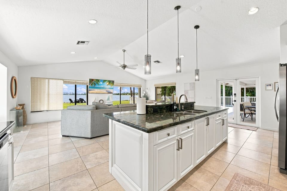 Open kitchen and living area showcasing a waterfront view through the windows.