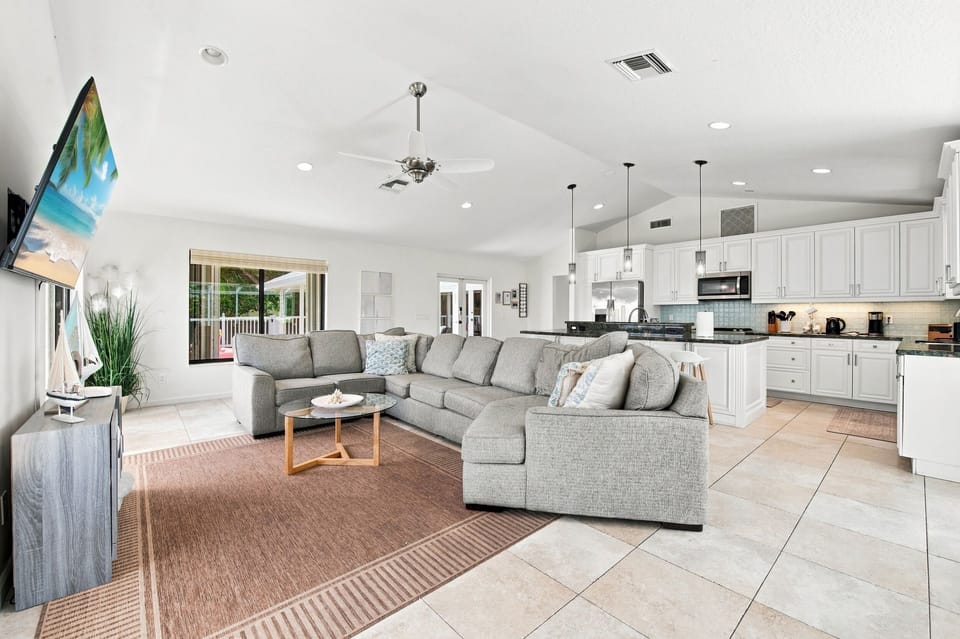 Cozy living room with a wall-mounted TV and comfortable seating.