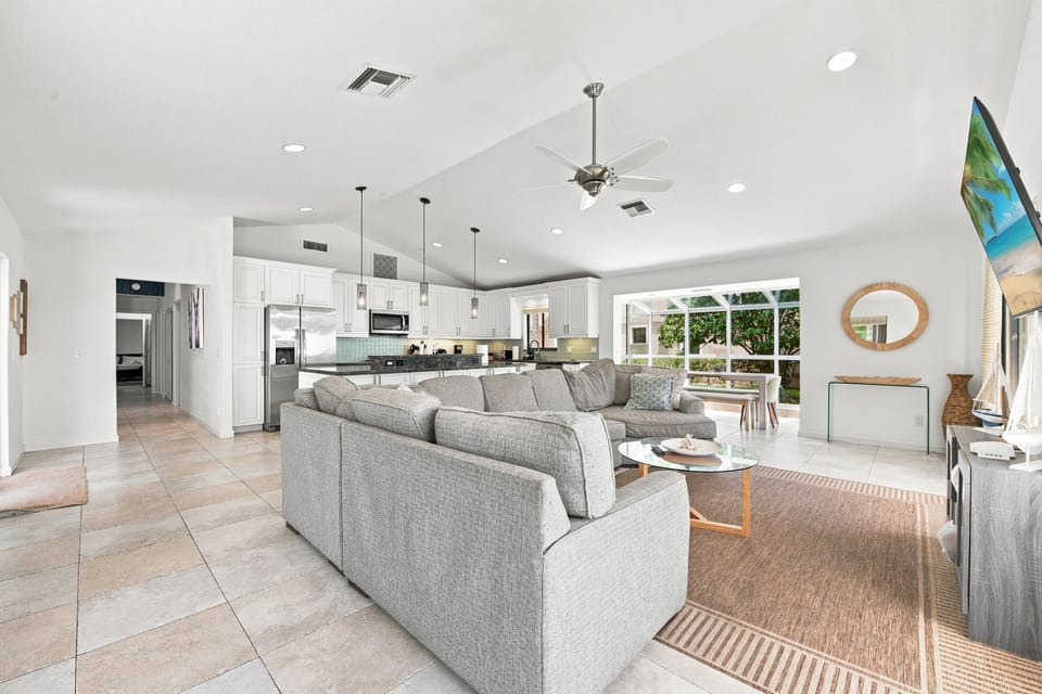 Open-concept living area with a spacious sectional flowing into the kitchen.