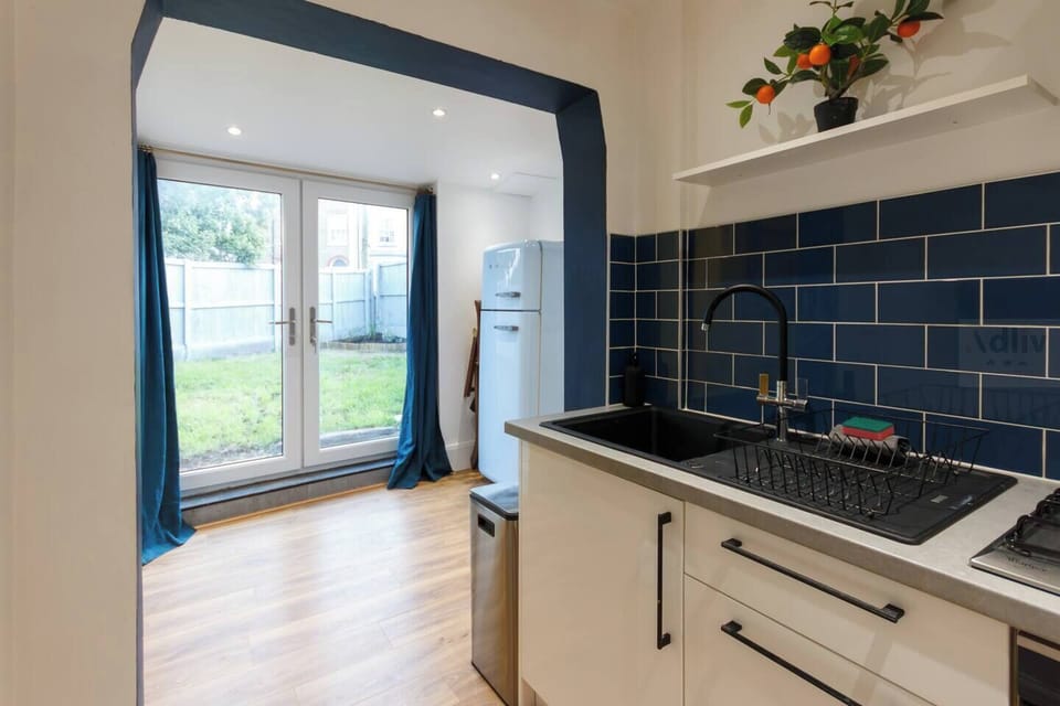 Bright kitchen with a retro fridge and stylish details, smoothly connecting to the dining area