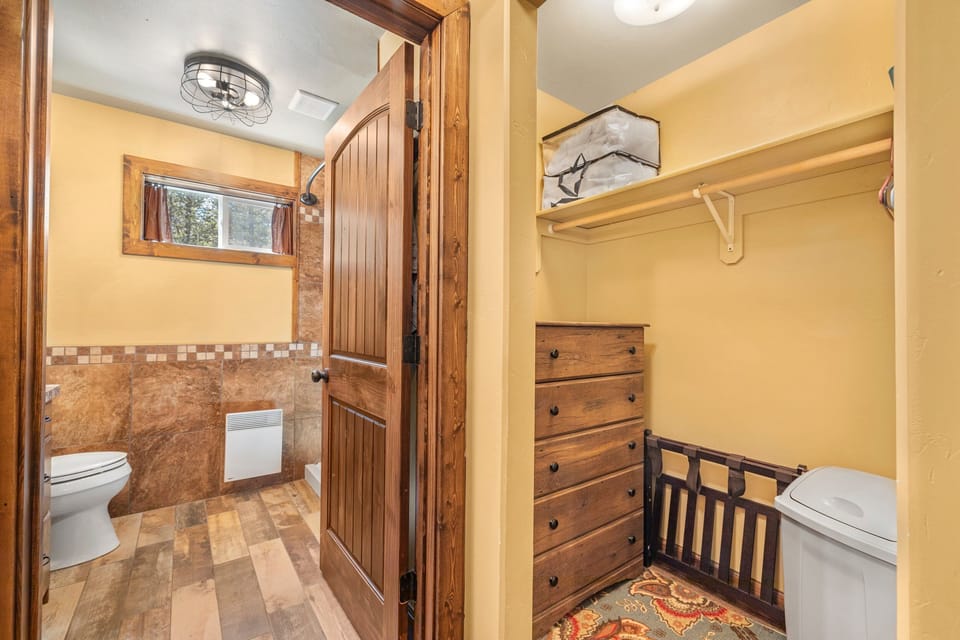 Jensen Pines ~ bedroom #1 on main level w/ king bed, TV, and ensuite bathroom