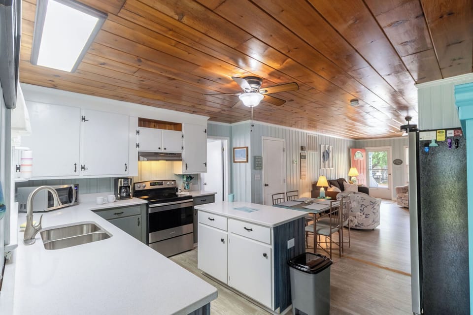Kitchen - Well-appointed kitchen featuring a sky light, upgraded appliances, and a cute island ideal for preparing home-cooked meals.