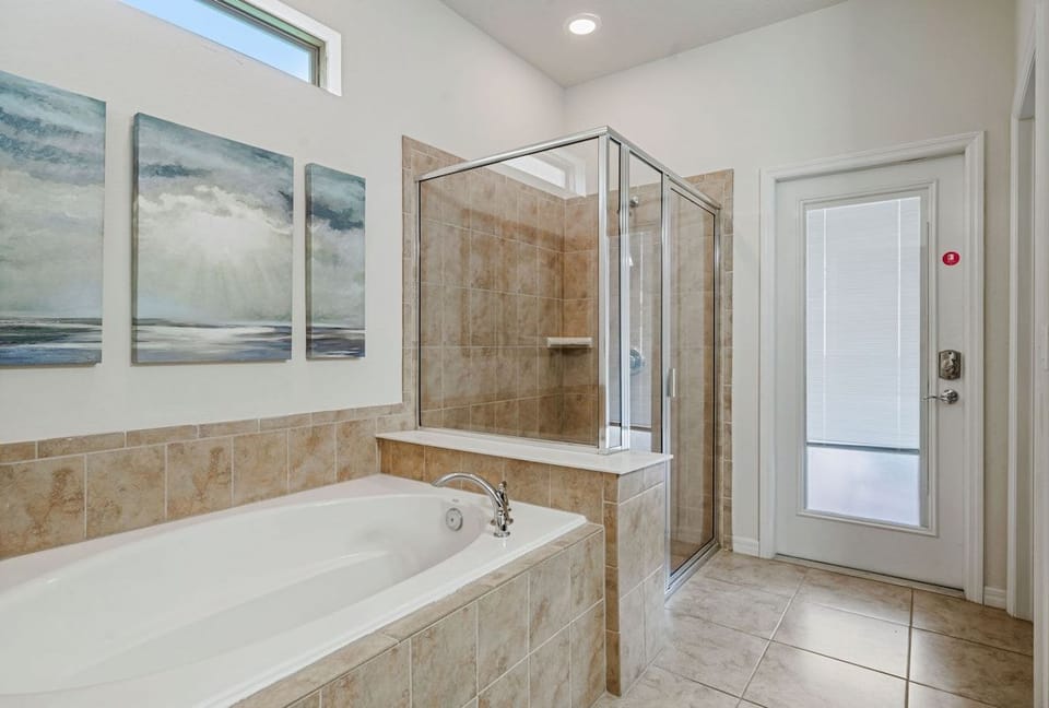 Bathroom 1 with a walk in shower and a bathtub