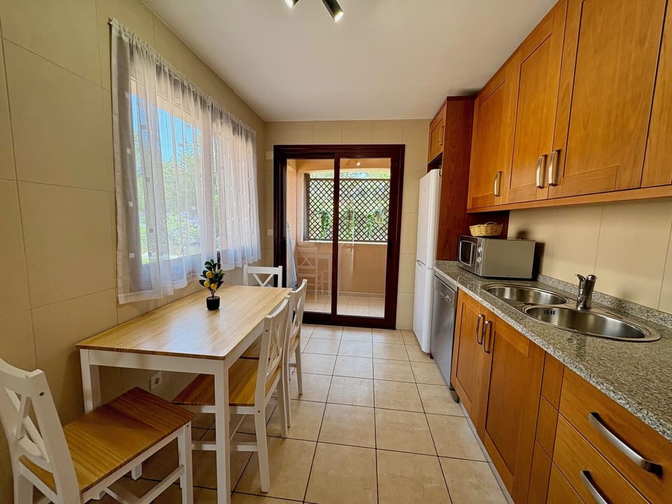 fully equipped kitchen with a laundry area on the balcony 