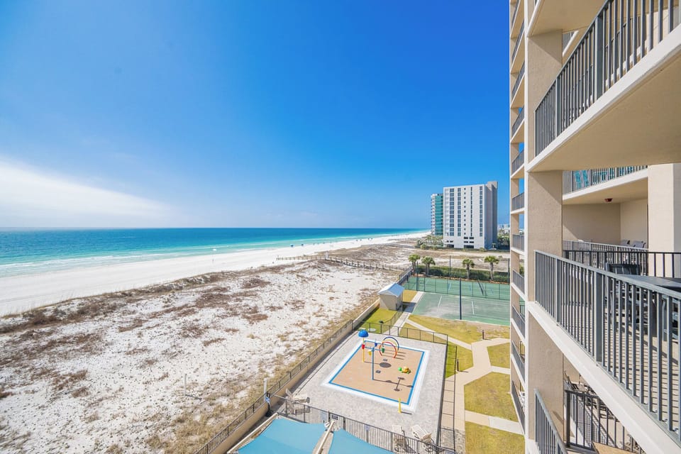Your balcony offers expansive views of the clear blue horizon and the gentle lapping of shore waves