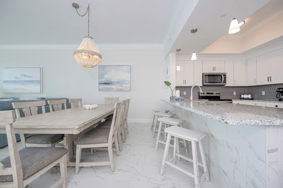 Gather around the spacious dining table, complemented by a stylish chandelier for memorable meals