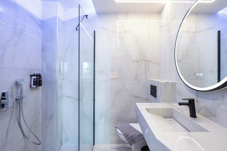 Grand Suite, 1 Bedroom, Sea View | Bathroom | Shower, slippers, towels, soap