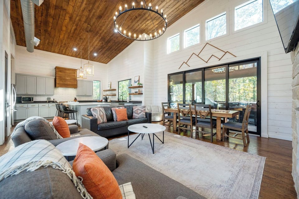 Inviting Broken Bow cabin living room with rustic charm and forest views!