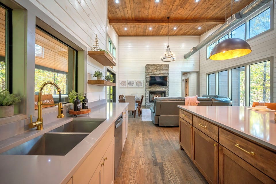 Cook with a view in our modern kitchen, featuring sleek countertops, gold accents, and an expansive island. Whether you’re brewing morning coffee or prepping a feast, you’ll love the open, airy feel of this space