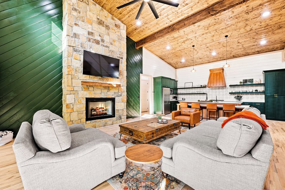 Cozy up by the stone fireplace—perfect for movie nights or morning coffee.