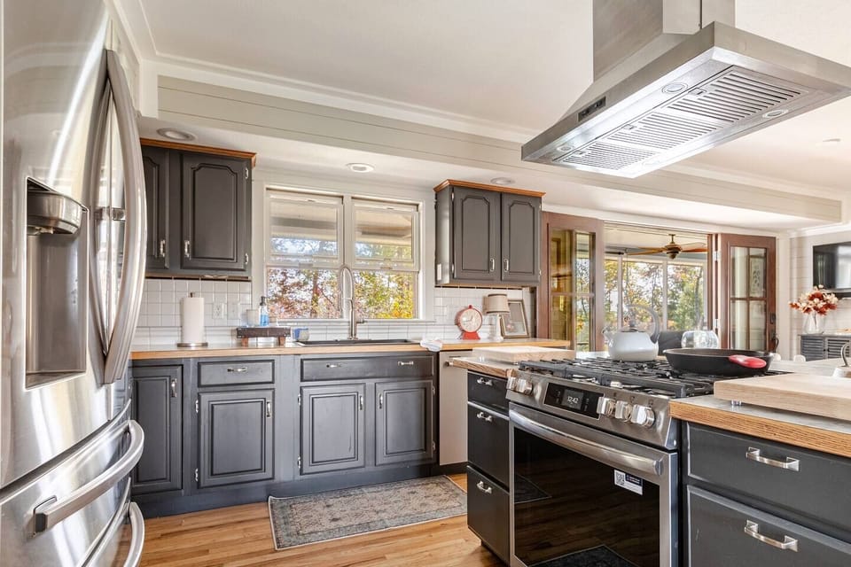 Modern appliances include a new gas range, large refrigerator and dishwasher.