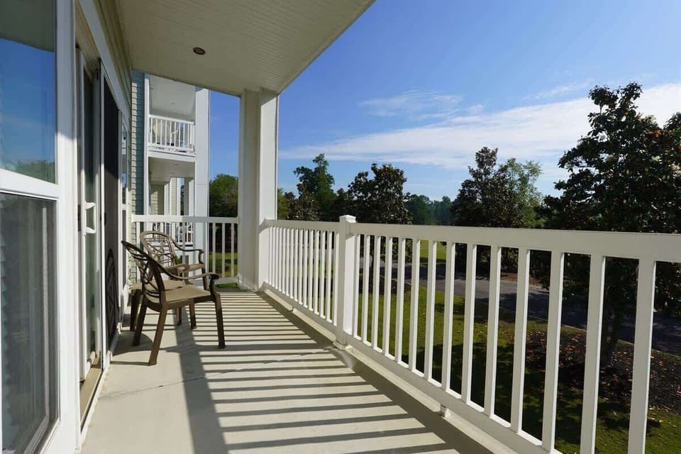 Balcony with Nature Covered balcony with seating for easy outdoor lounging