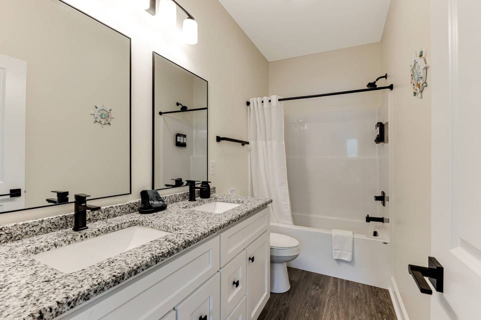 Modern Primary bathroom with double vanity and a tub/ shower combo